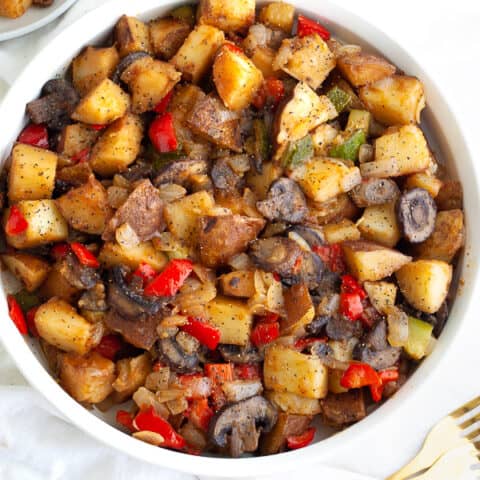 Vegan breakfast hash in a large white bowl.