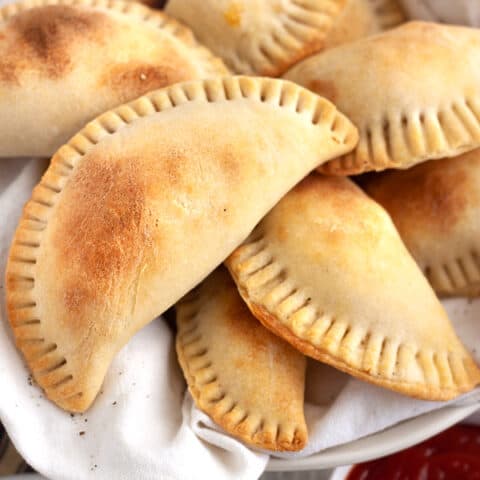 Empanadas in a white bowl.