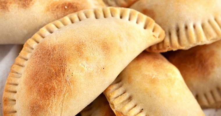 Empanadas on serving plate.