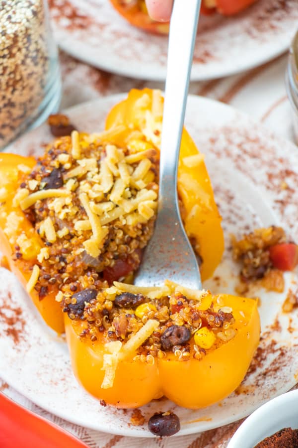 Stuffed yellow pepper with a bite cut off on a fork.