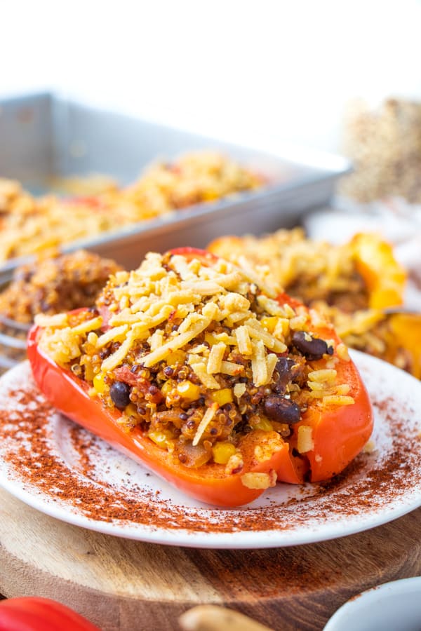 Close up picture of red pepper with quinoa filling and vegan cheese.