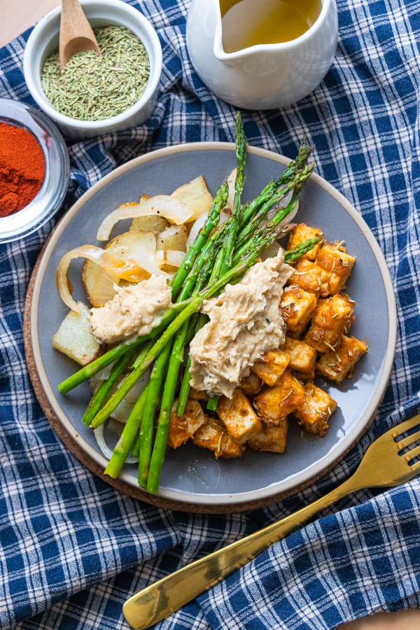 Tofu and veggies on grey plate