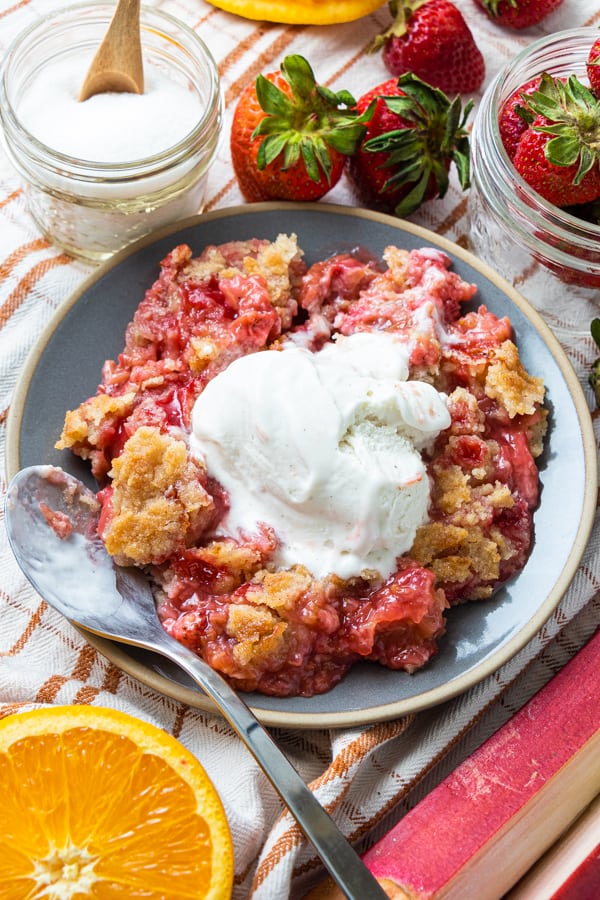 Crumble on Gray Plate with Berries Surrounding.