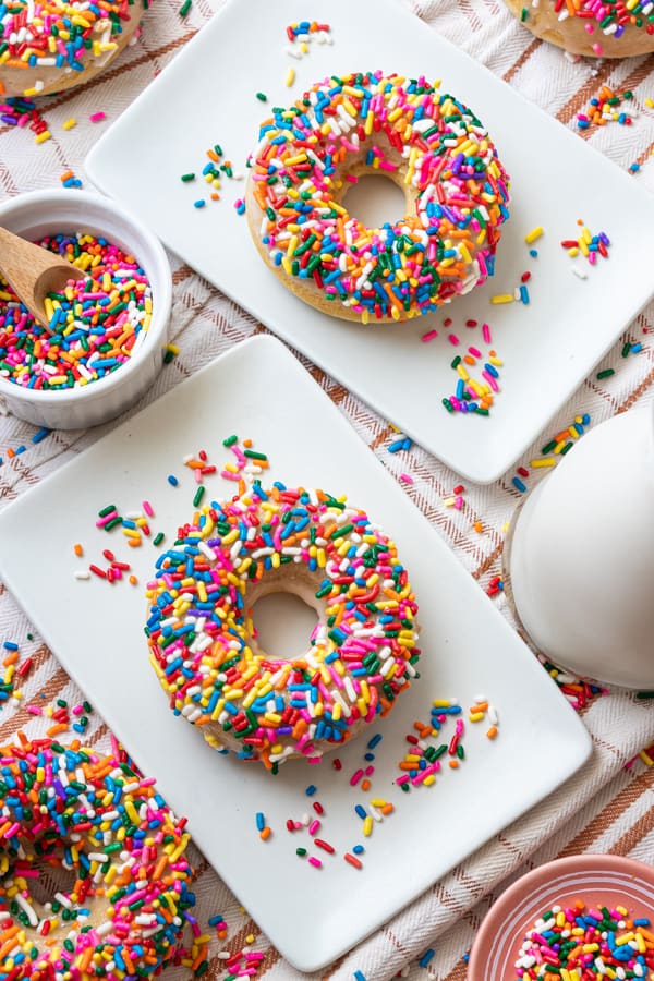 Donuts on plates with sprinkles in bowl