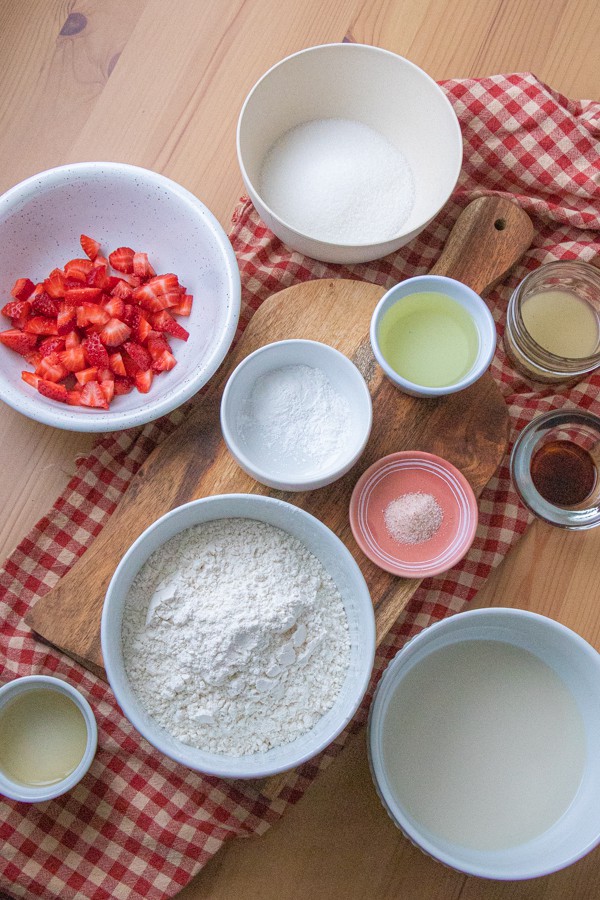 Strawberry donut ingredients in bowls.