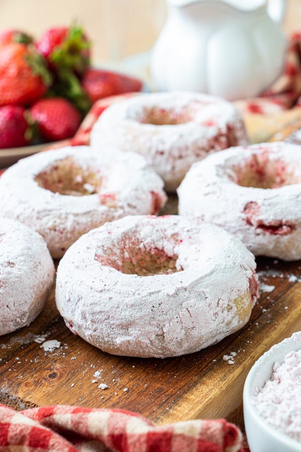Powdered donuts on plate.