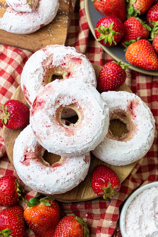 Donuts on plate with strawberries.