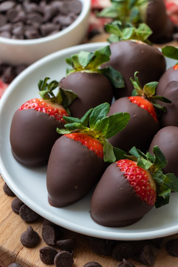 Chocolate covered strawberries on plate.
