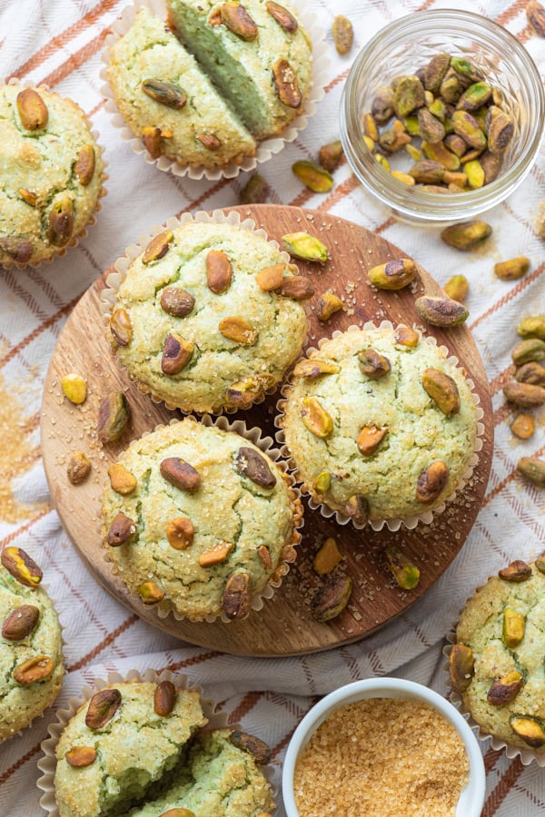 Baked muffins with pistachios in them.