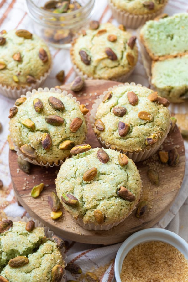 Pistachio muffins on serving board.