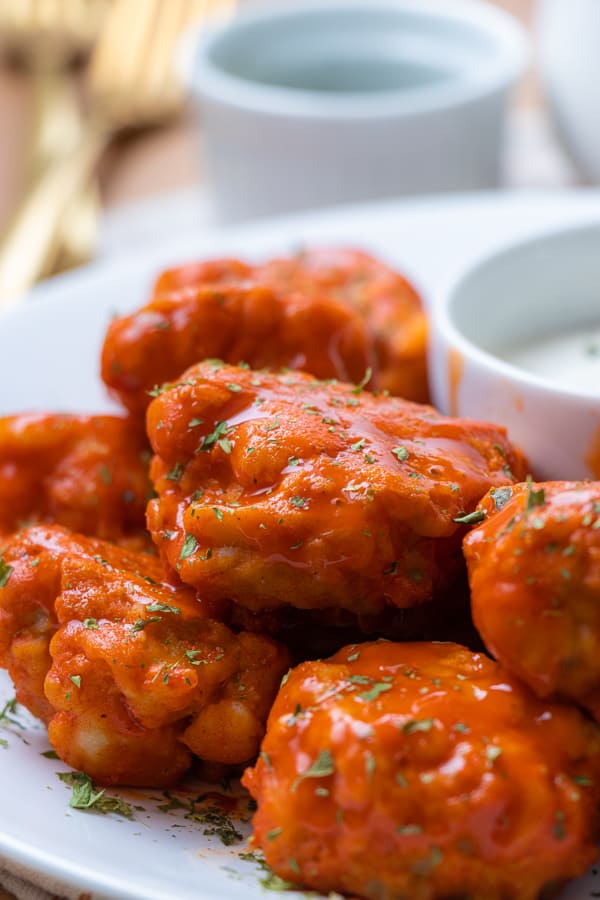 Wings with buffalo sauce and parsley.