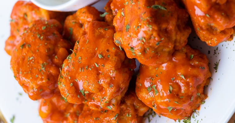 Chicken wings with buffalo sauce on plate.