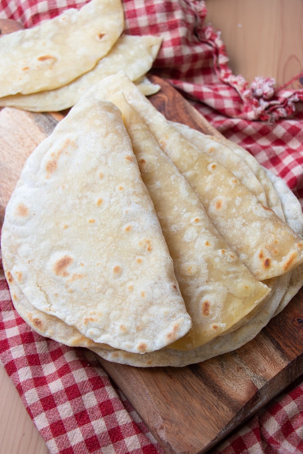 Folded tortillas on board.