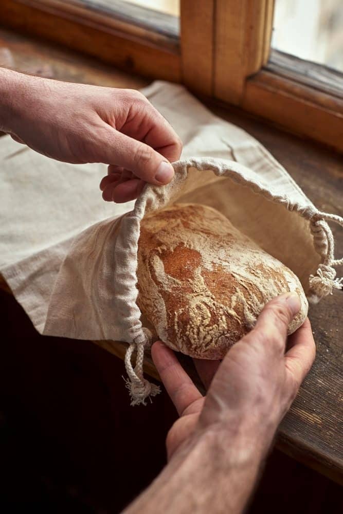 Bread being put in a bag